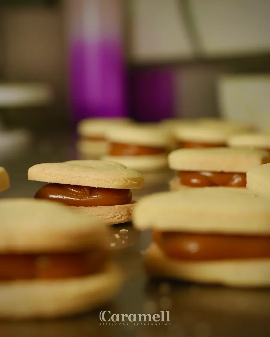 Alfajores Caramell recién armados, con el arequipe asomando entre las dos galletas